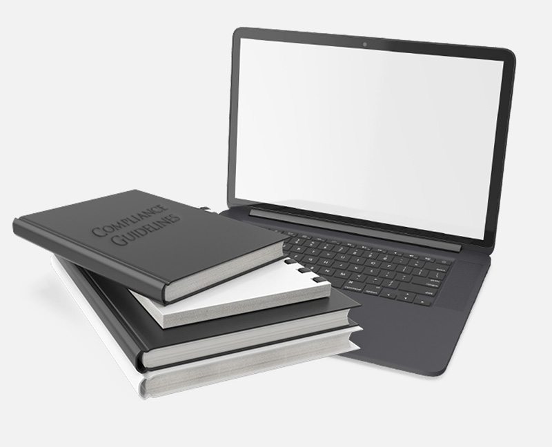 Picture of laptop and compliance book