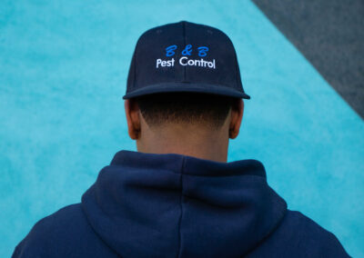 BBPest Control Employee wearing B&BPest Control baseball hat backwards | Corporate Photography Services